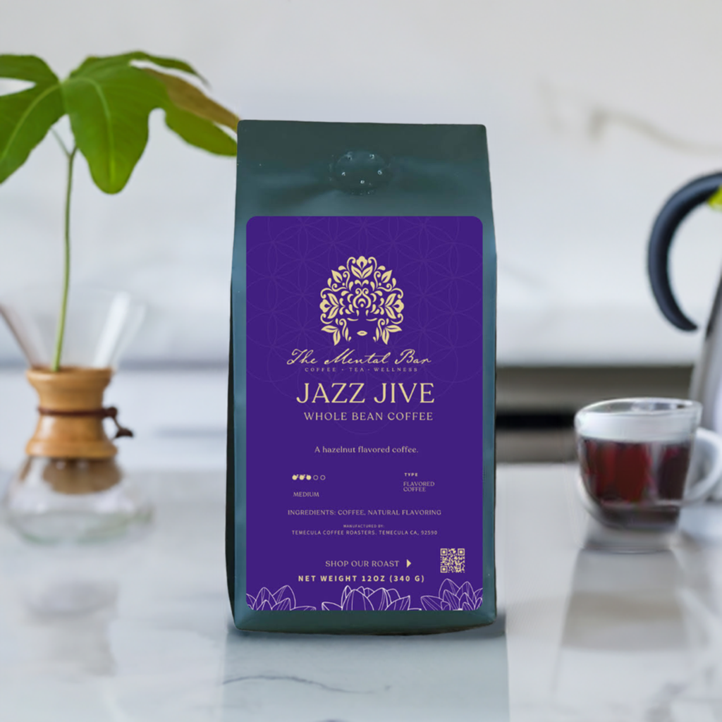 A pack of Jazz Jive flavored coffee by The Mental Bar, with a purple label and design, placed on a kitchen counter.