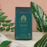The Mental Bar Single Origin Coffee Sample Pack, featuring six 2-ounce coffee bags in a tropical setting.
